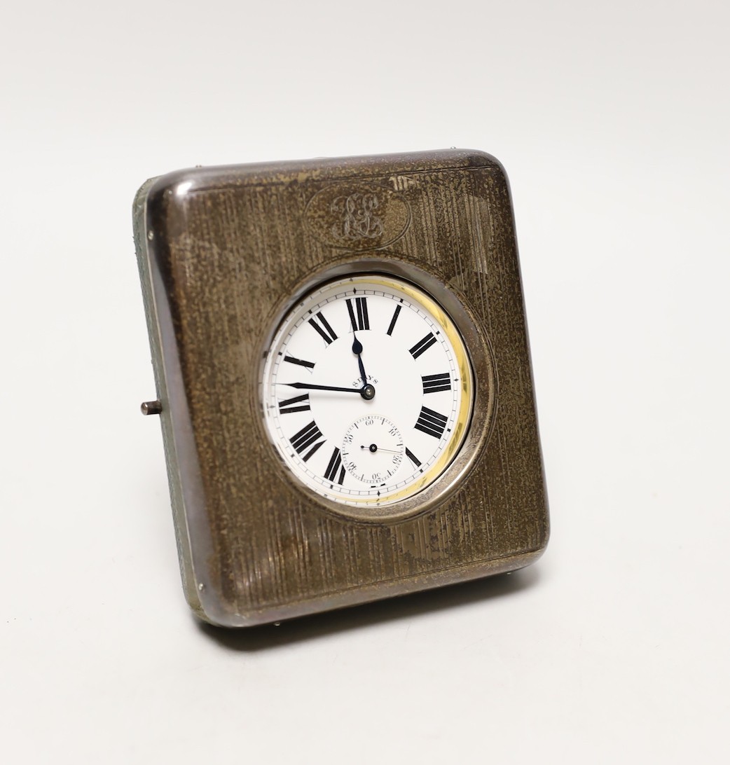 An Edwardian silver mounted travelling watch case, Birmingham, 1906, containing a nickel cased pocket watch, case diameter 66mm.